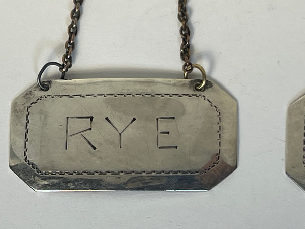 Set of Two American Sterling Silver Rye and Scotch Decanter Labels