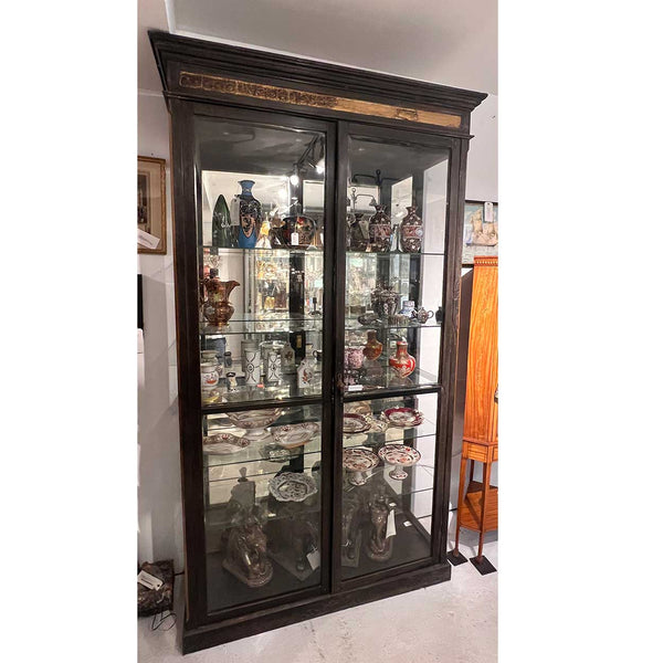 Lot 217 | Large Anglo Indian Teak, Mirrored and Beveled Glass Double Door Display Cabinet