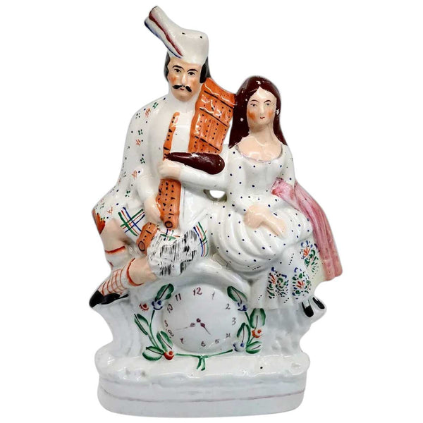 Large English Staffordshire Pottery Flatback Figural Group of a Scottish Couple and Clock